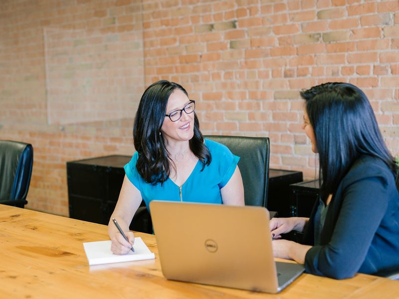 A We Are Next Target representative having a friendly, face-to-face conversation with a client